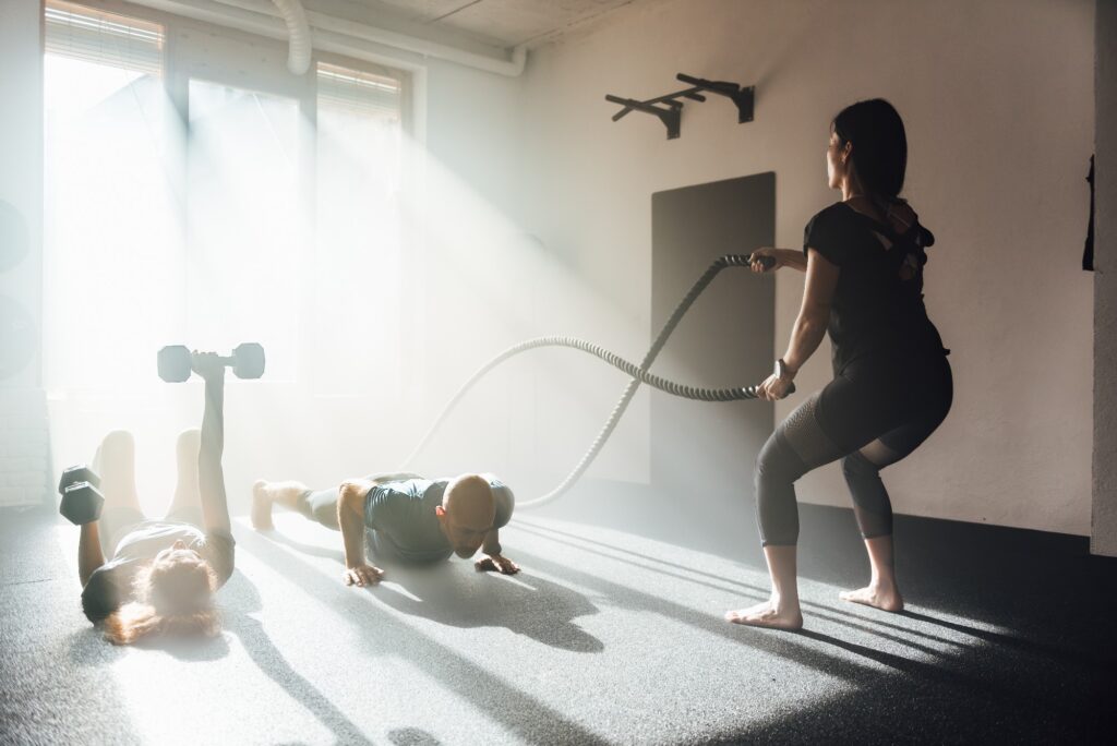 Active People Exercising Together In Gym